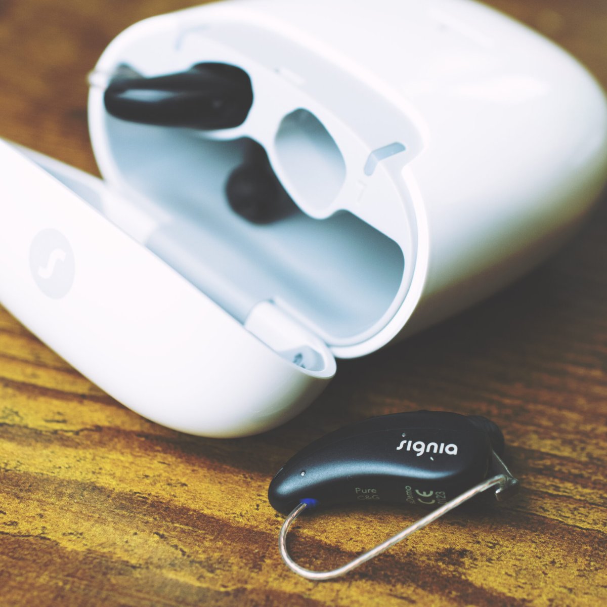 Signia Pure hearing aid with modern charging case showcasing latest digital hearing technology