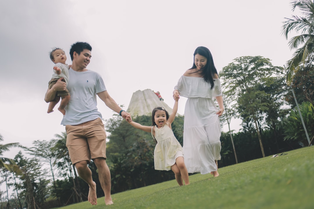 Happy family enjoying clear vision together on a grassy hill